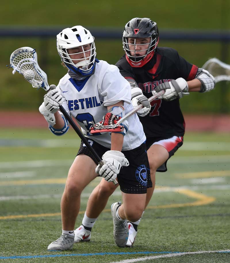 two lacrosse player battling for the ball
